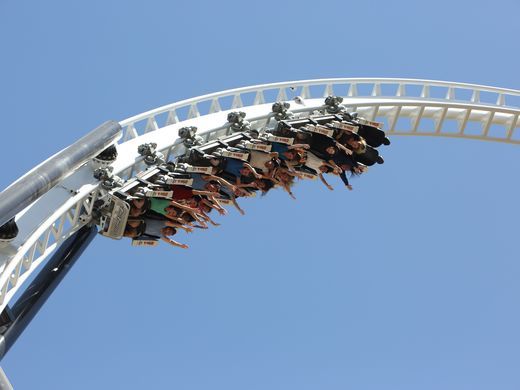 riders on the thrilling coaster FULL THROTTLE going around the loop